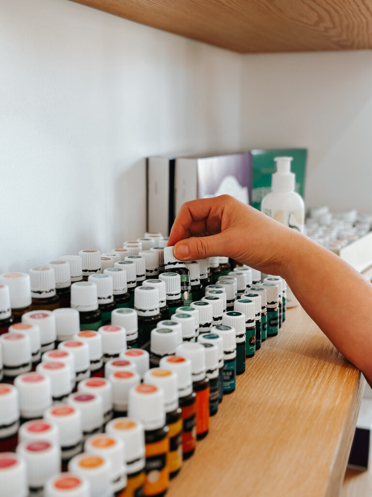 Shelf filled with essential oils and natural remedies, choosing essential oils over alternatives